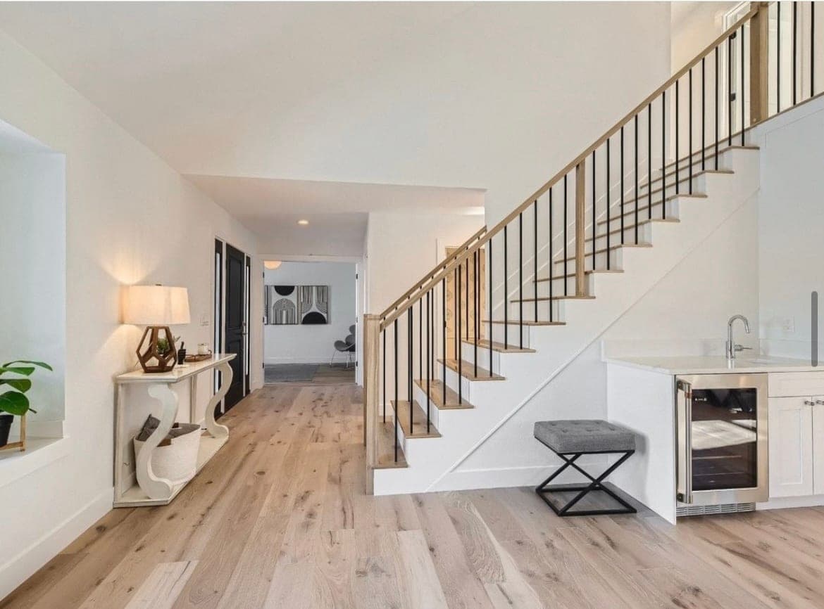 Wide-plank white oak hardwood flooring flowing through a bright open home