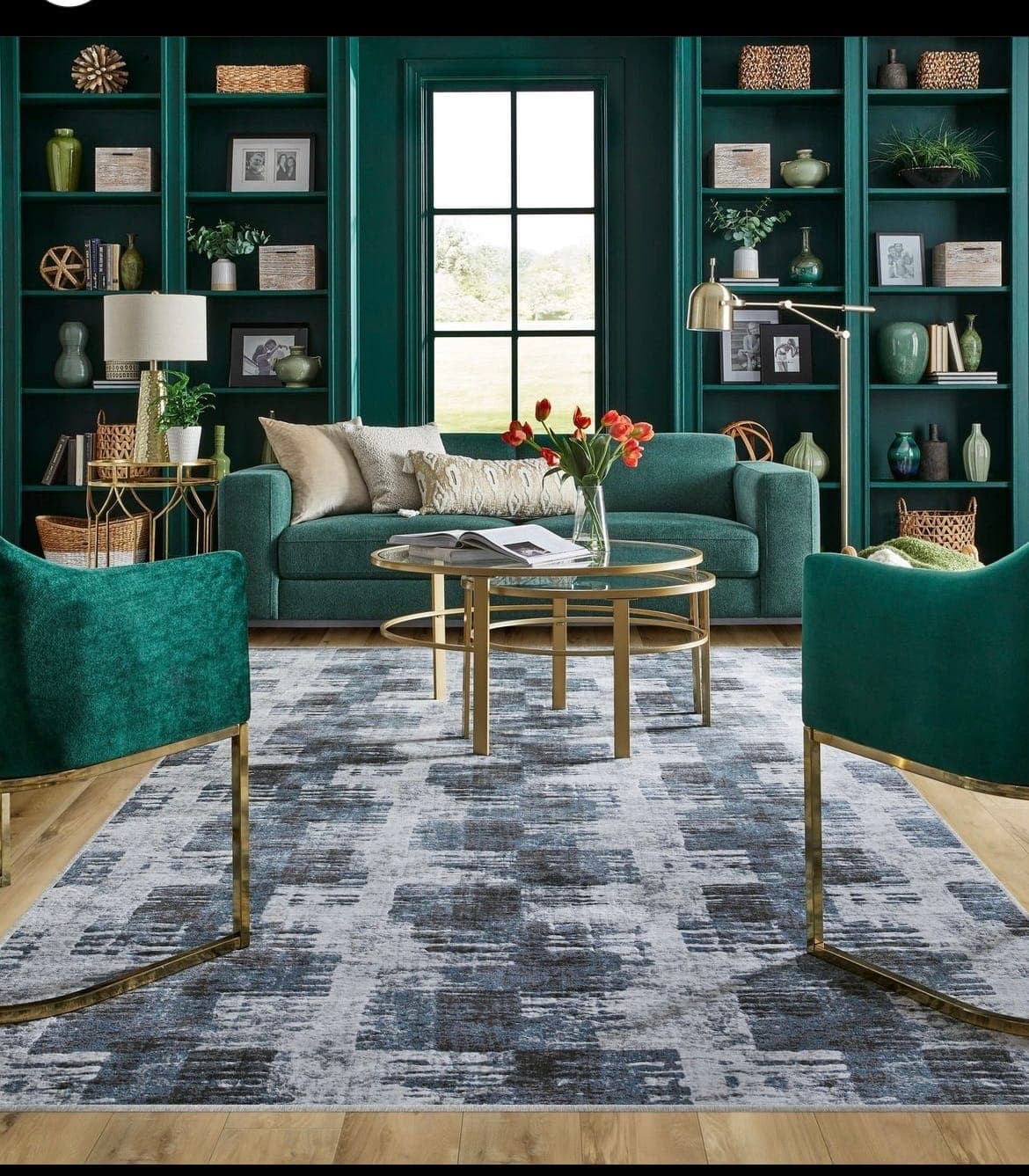 Layered patterned area rug in an emerald sitting room