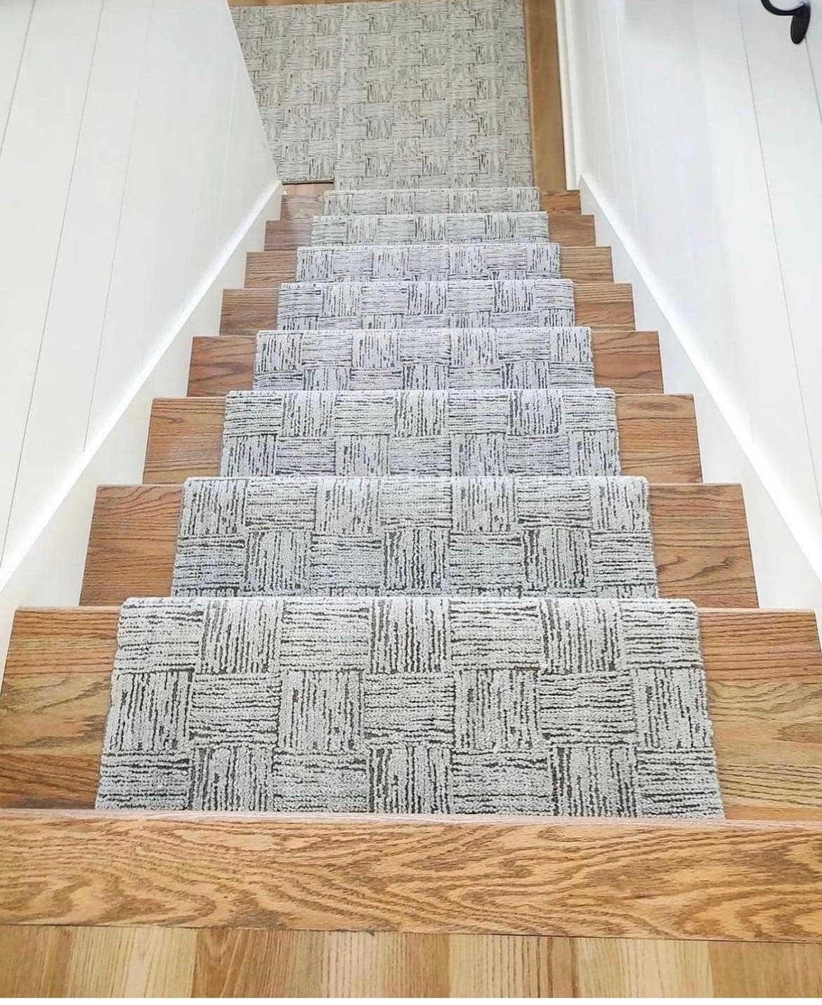 Styled interior with coordinated window treatments and a staircase runner